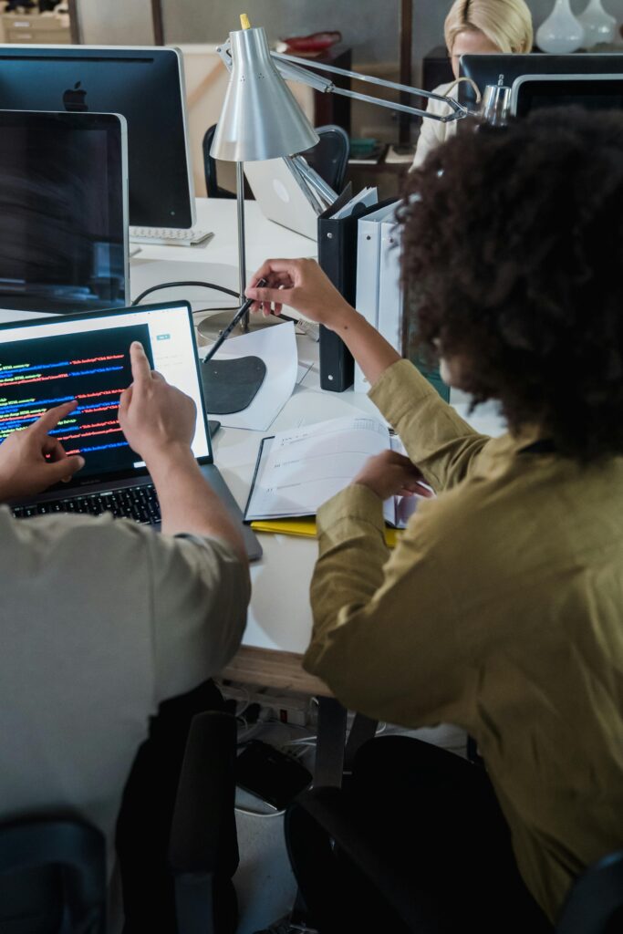 Back View of People Working in a Team on a Code